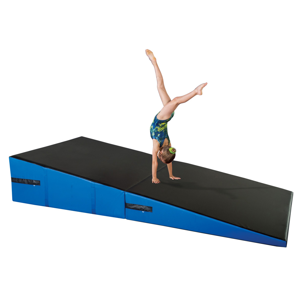 gymnast practicing on blue and black folding incline wedge mat