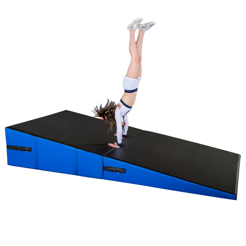 cheerleader practicing on blue and black folding incline wedge mat