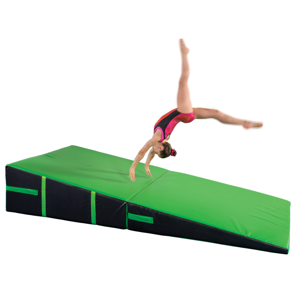 gymnast practicing on black and green folding incline wedge mat