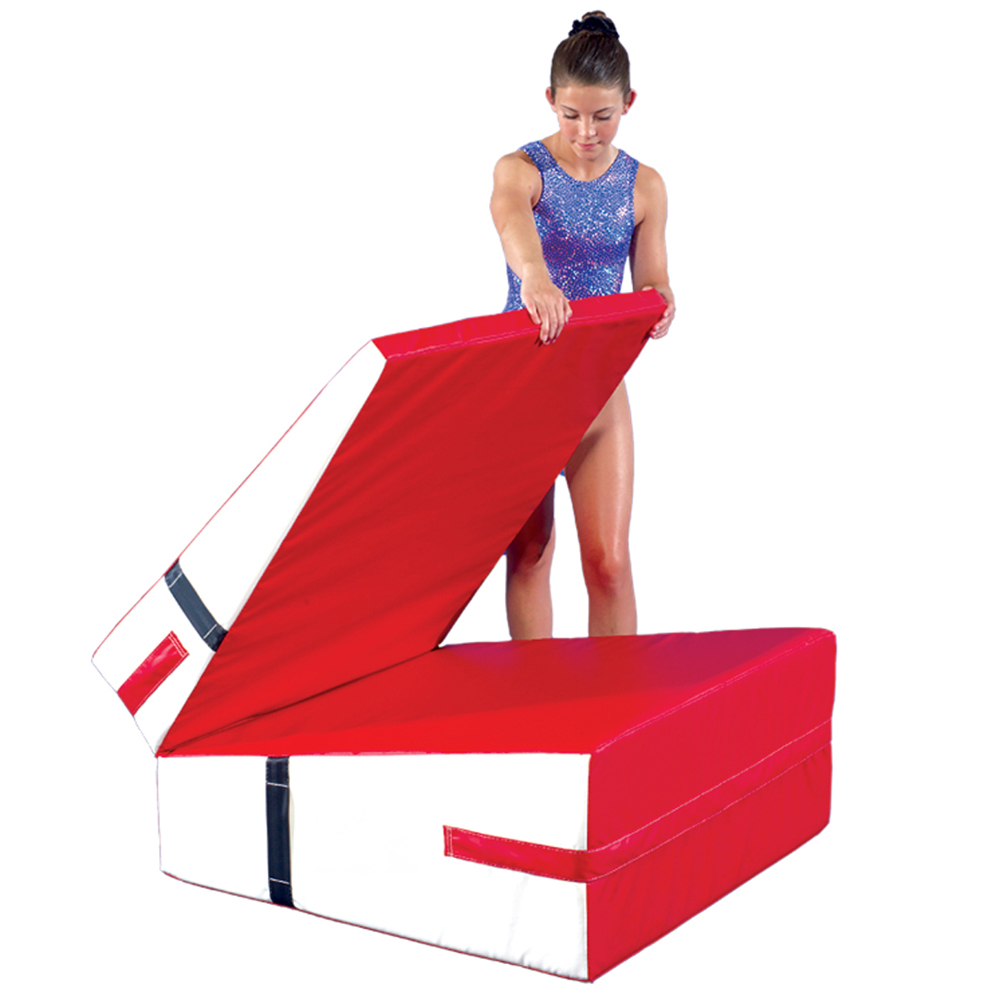 gymnast folding up red and white incline wedge mat