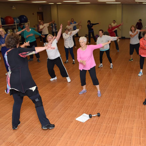 group of people doing aerobic exercises on ez portable dance floor tile