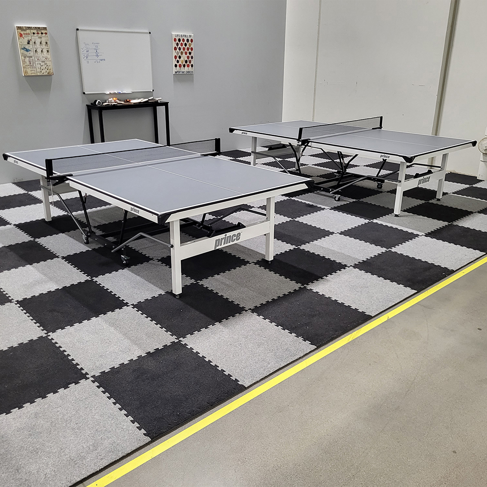 light and dark gray carpet tiles in game room with ping pong tables