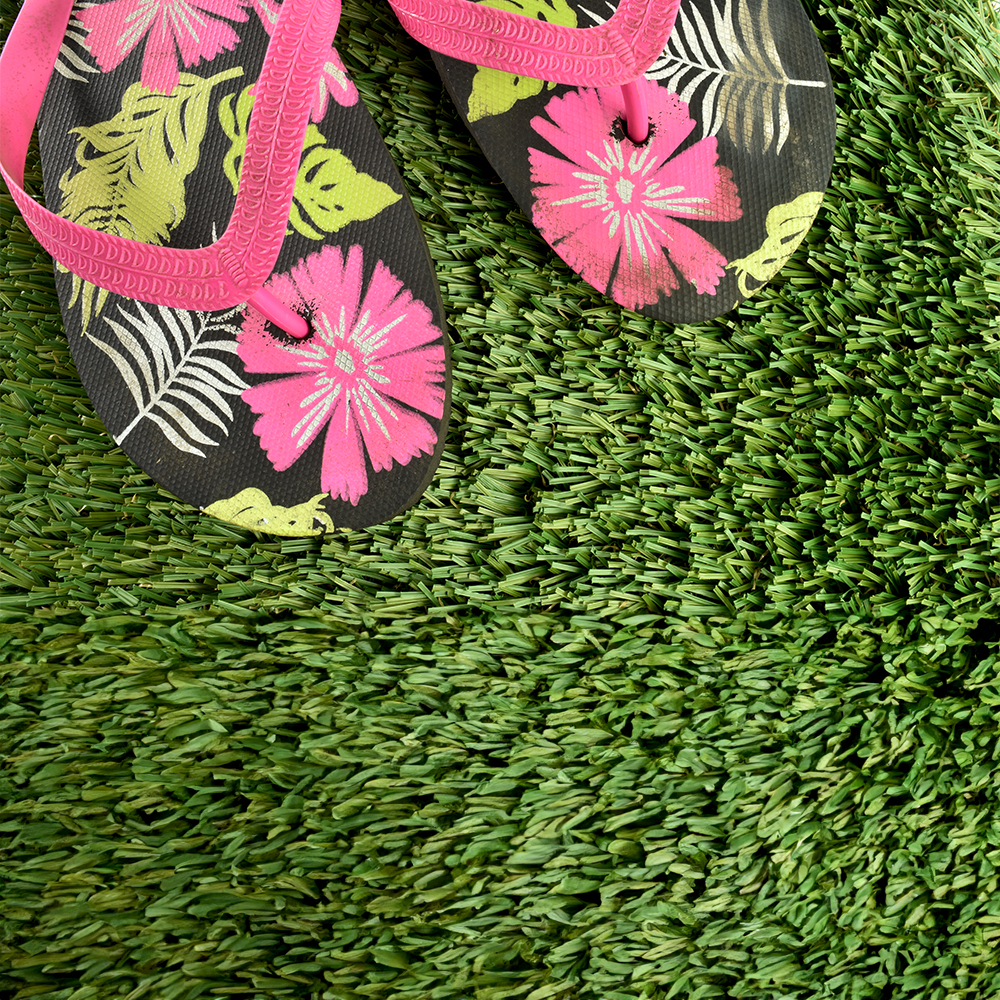 ZeroLawn Standard Artificial Grass Turf 1-1/2 Inch x 15 Ft. Wide per SF top view with flip flops