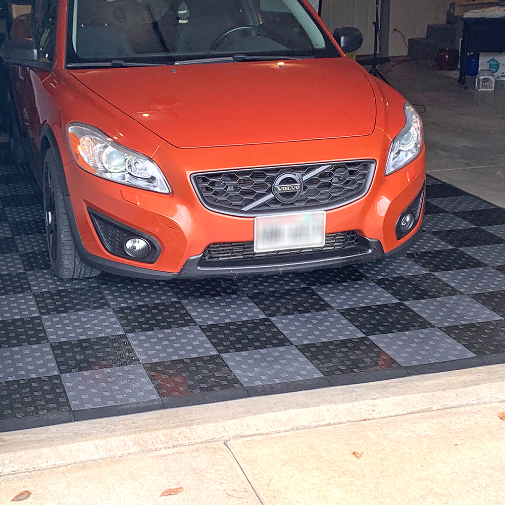 border ramps on garage floor tiles in garage with car