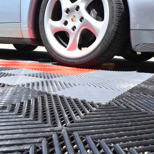 car parked on perforated click together garage floor tiles