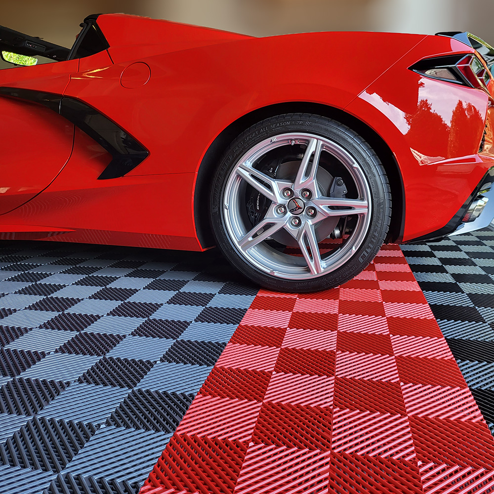 red corvette parked on red black and gray interlocking garage flooring tiles