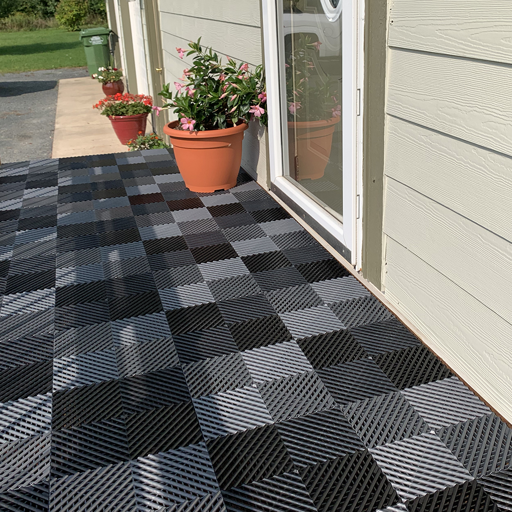 plastic garage tiles installed over wood deck - checker pattern