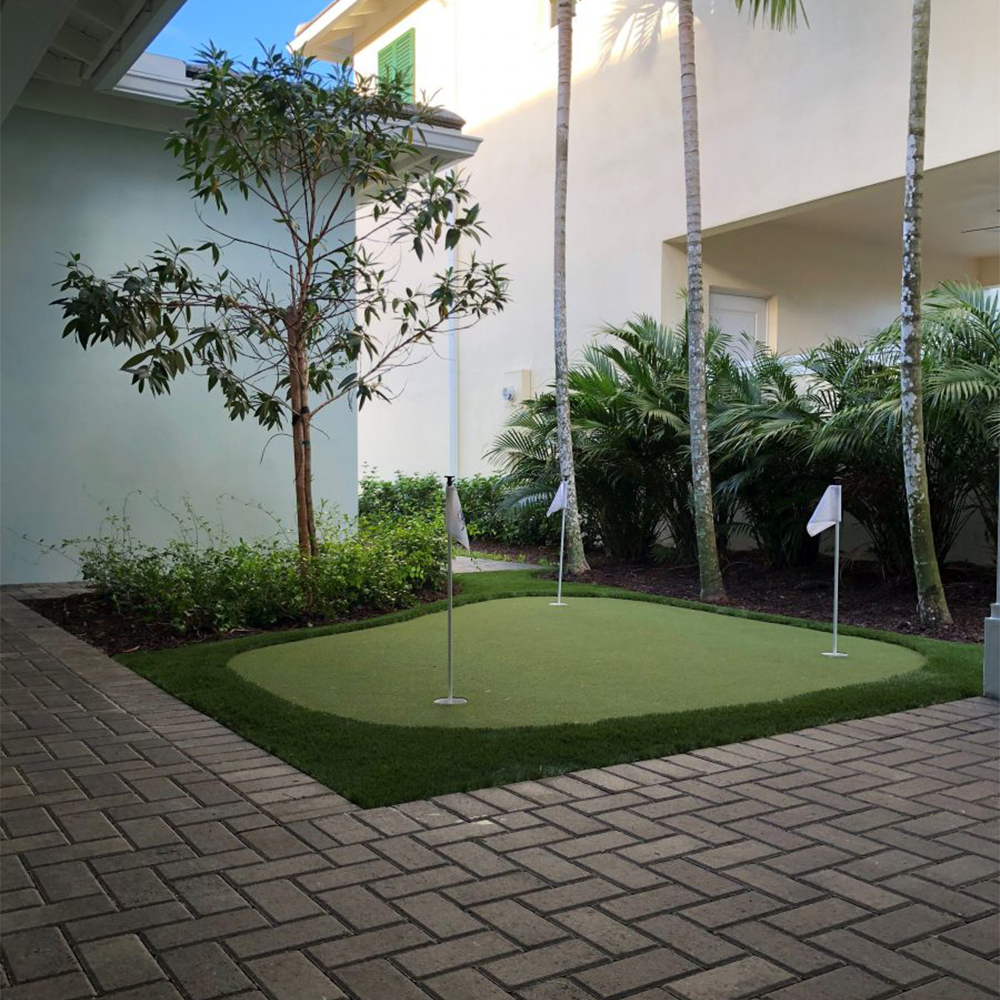 Money Putt Artificial Grass Turf Roll 15 Ft in small putting green surrounded by brick pavers
