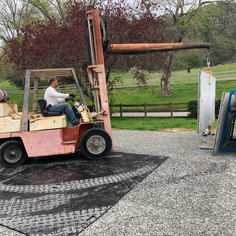 Forklift lifting materials driving on Gmats Ground Protection Mat 