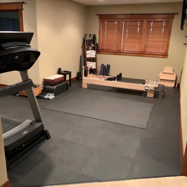 interlocking flooring mats in home gym with exercise equipment