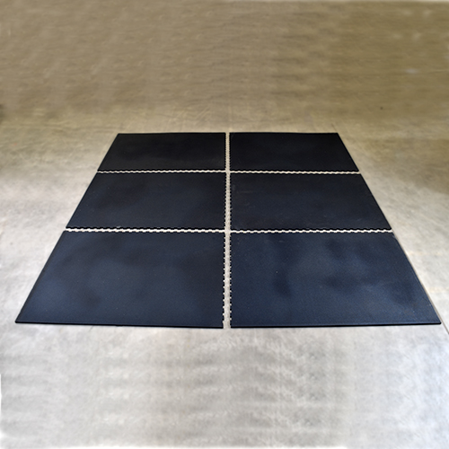 six interlocking horse stall rubber mats laid out on concrete