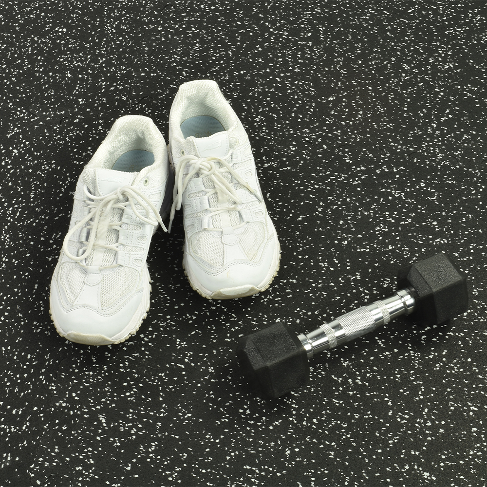 interlocking Rubber Floor Tiles Gmats with light gray flecks with tennis shoes and dumbbell