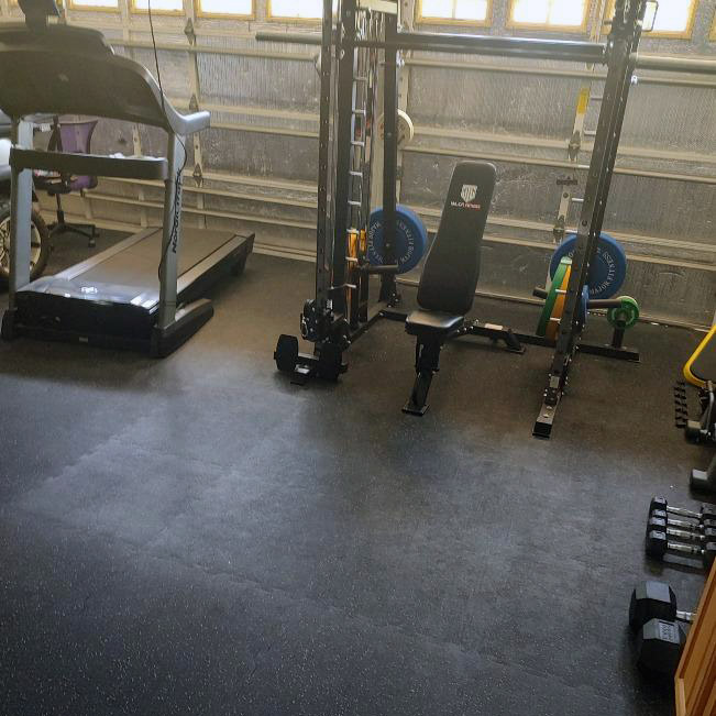 interlocking rubber tiles in garage gym with workout equipment