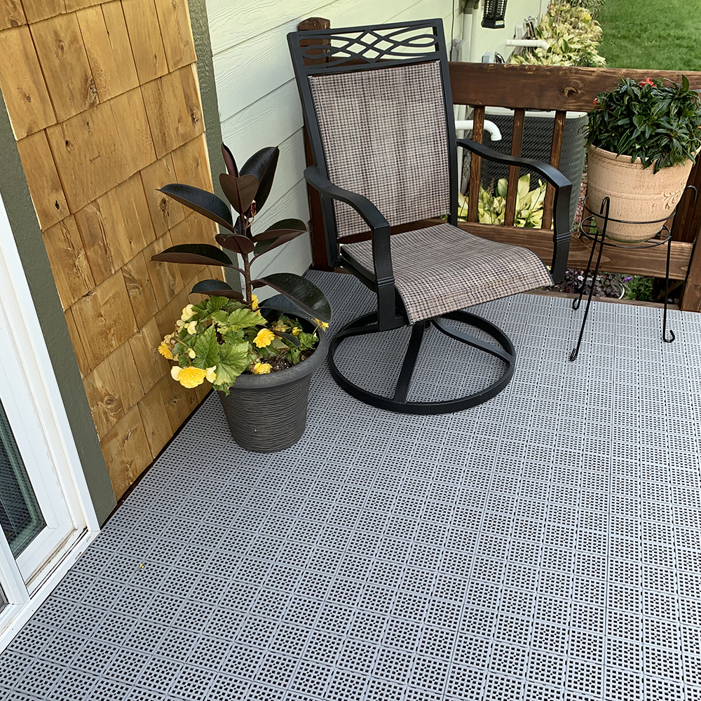 gray outdoor tiles installed over wood deck