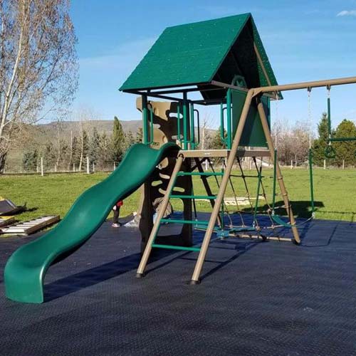 backyard playground using staylock outdoor tiles over grass