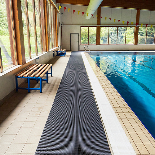 Heronrib Wet Area Safety Matting Roll next to indoor pool