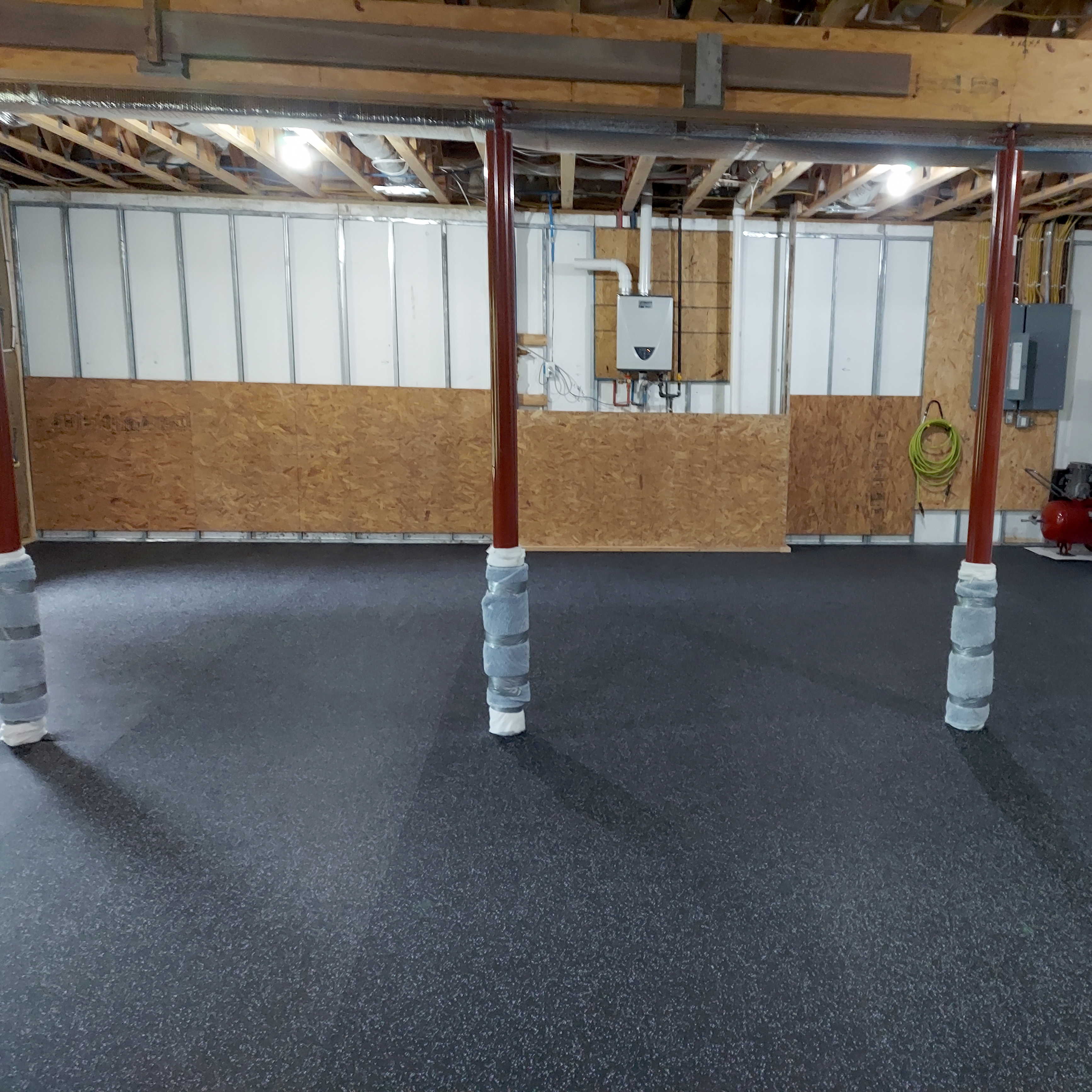 basement with rolled rubber flooring for home gym weight room