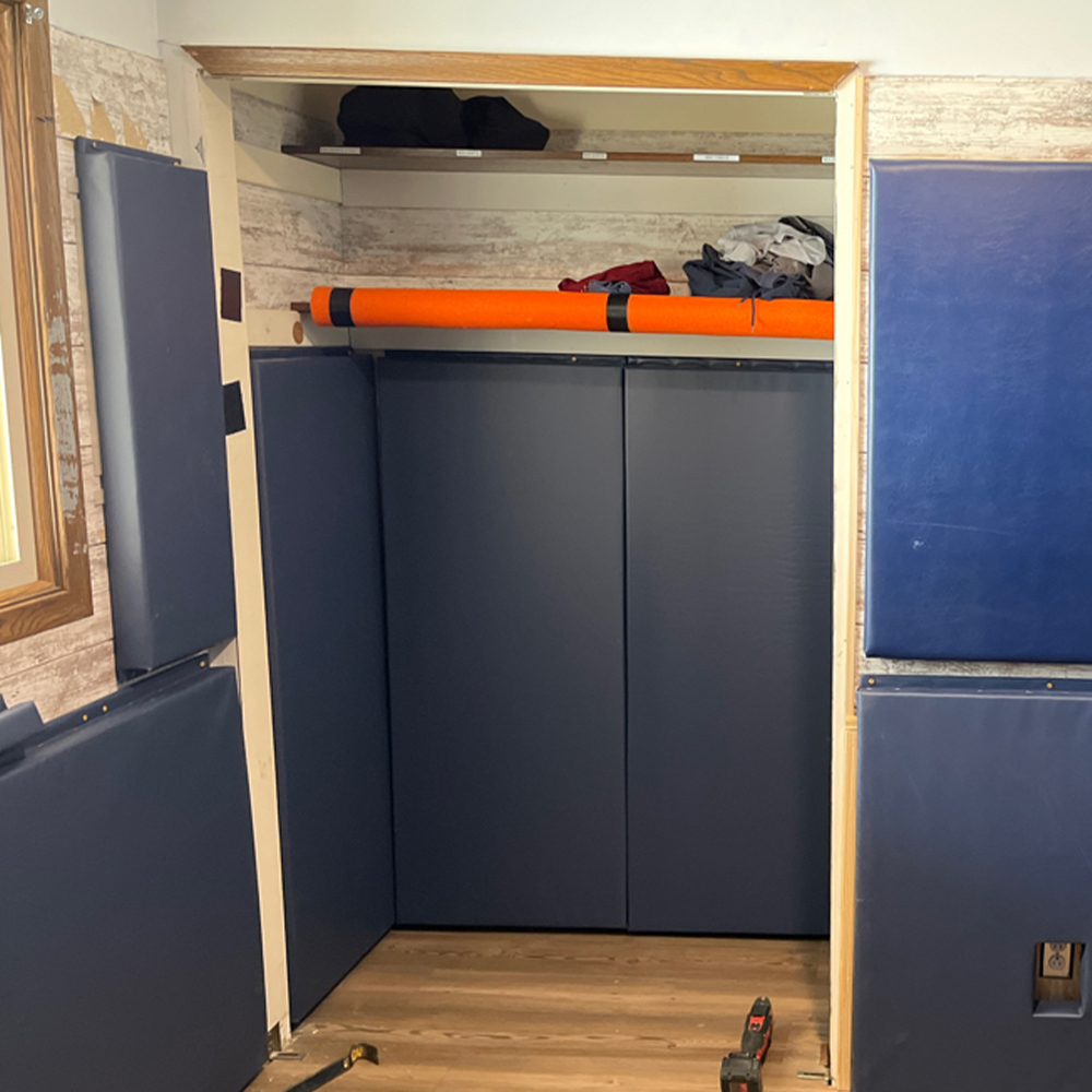 2x5 foot blue safety wall pads installed in closet in disability home