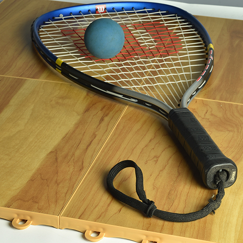 Portable Racquetball Court flooring tiles with a raquet and ball
