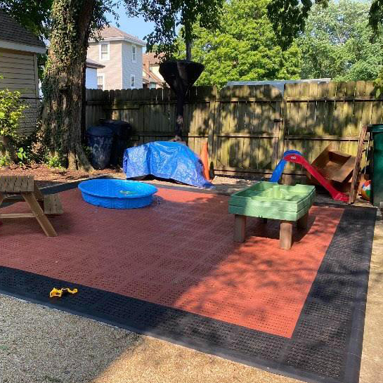 Staylock Perforated Outdoor Floor Tiles in kids play area terra cotta color.