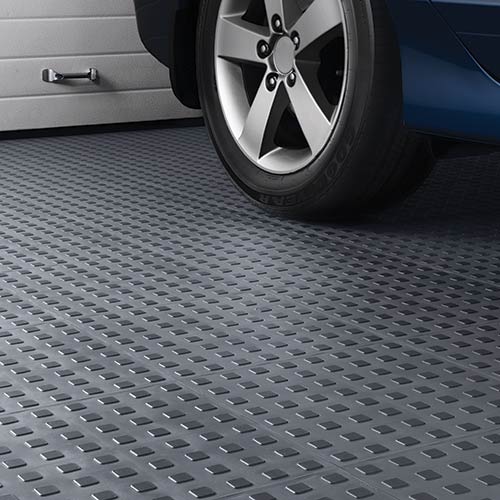TechFloor Premium Tile with Traction Top garage floor with tire.