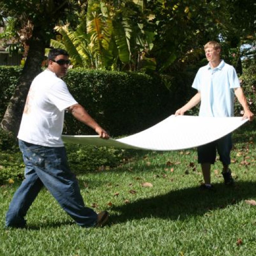 two men carrying VersaMats Diamond Foot ground protection mat