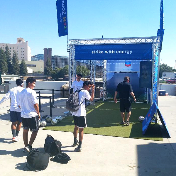 flexturf roll at outdoor trade show with people kicking soccer balls