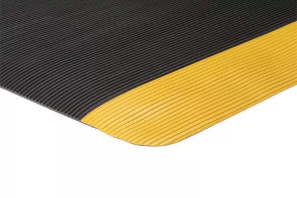 close up of corner of invigorator fatigue mat in black color with yellow border