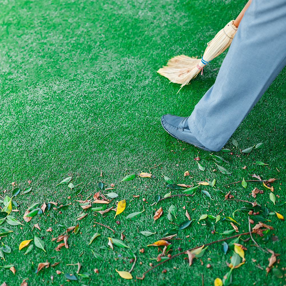 sweeping leaves on artificial grass