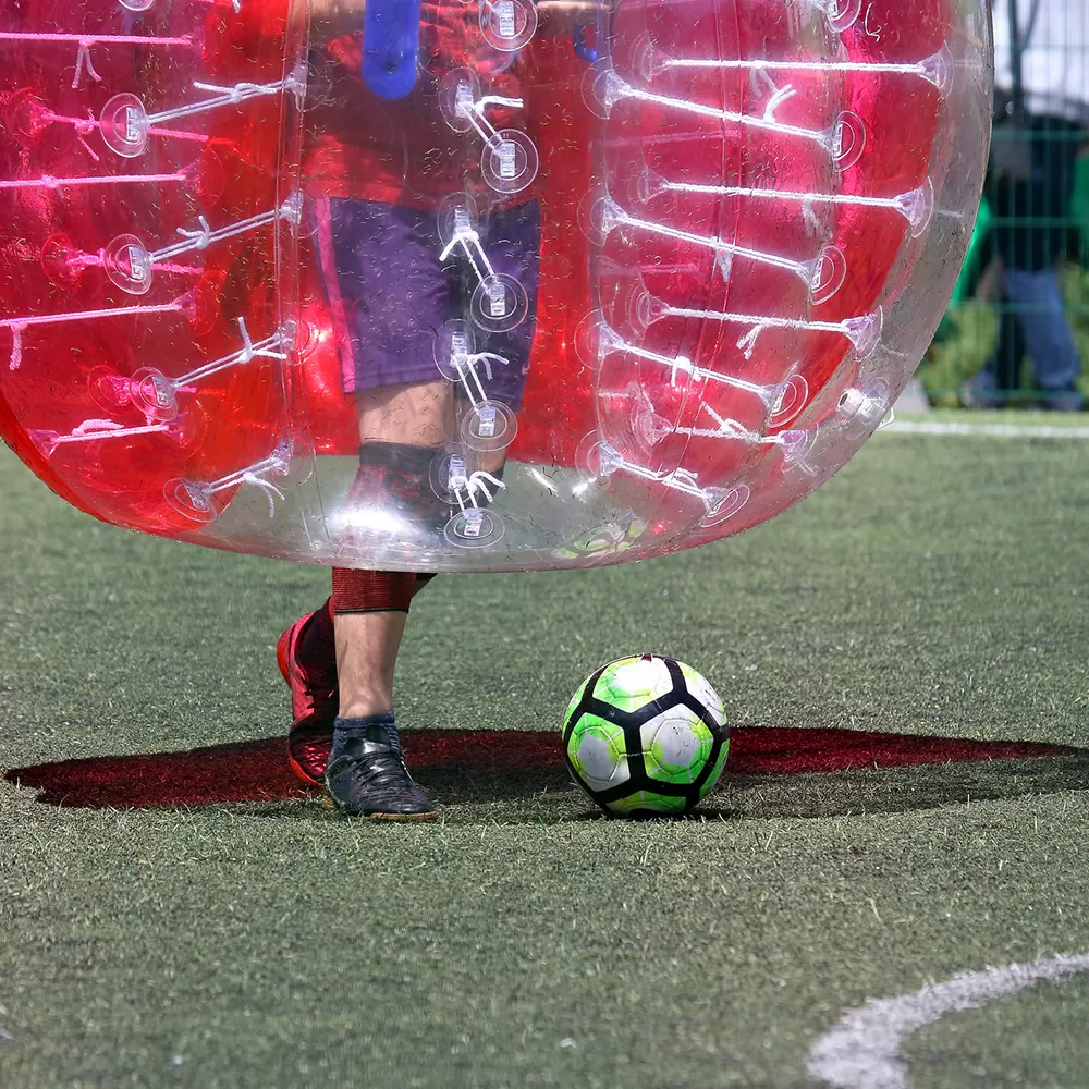 playing bubble soccer outdoors