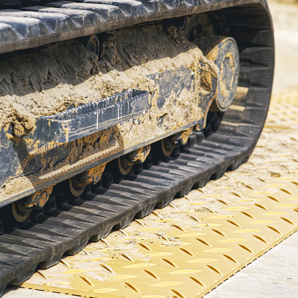 Blue Gator Lite Ground Protection Diamond Mat Tan 3/8 Inch x 4x8 Ft. driving on with rubber tracks