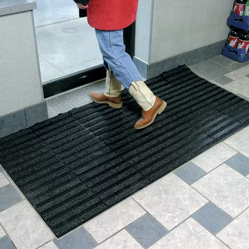 Entrance Tile 1/2 inch Black w/Charcoal Carpet at doorway.