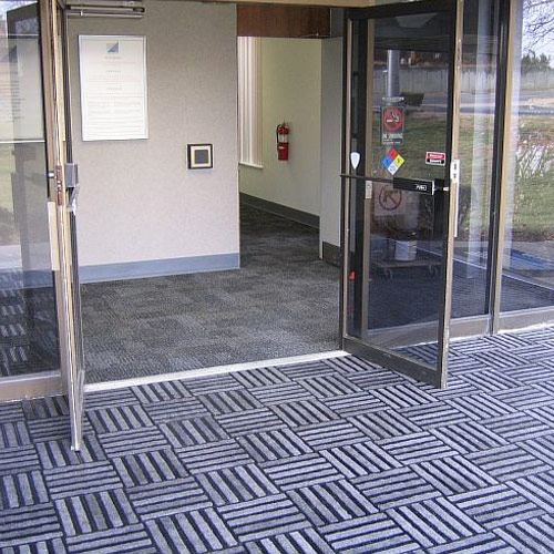 entrance carpet tiles arranged in quarter turn pattern