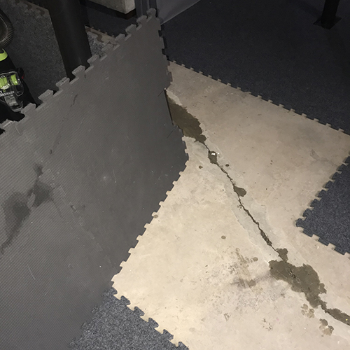carpet squares removed for wet concrete floor