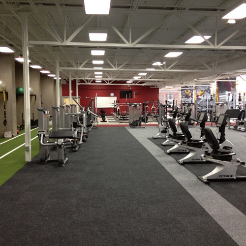 gray gym carpet tiles installed in commercial gym