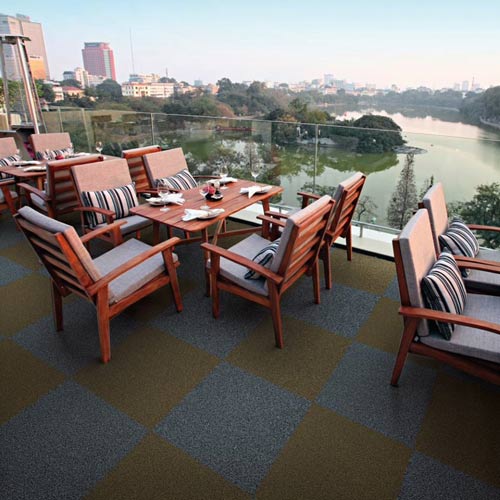 grizzly grass carpet tiles in gray and brown on large balcony over looking a river