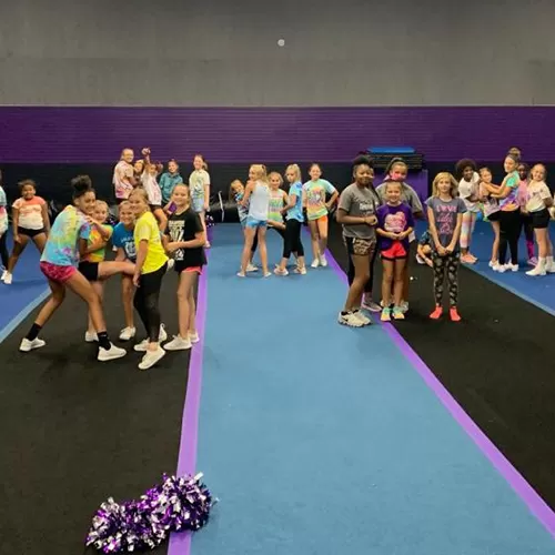 Large group cheerleading practice on cheer mats