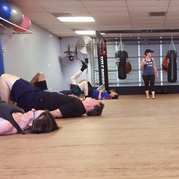 fitness center exercise classes on foam mat flooring