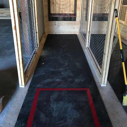 Axe throwing practice stall using rubber flooring rolls