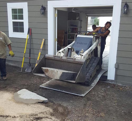 Landscaping Mats under mini loader in doorway