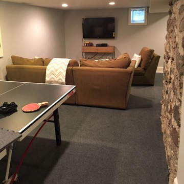 family game room in basement carpet tile flooring