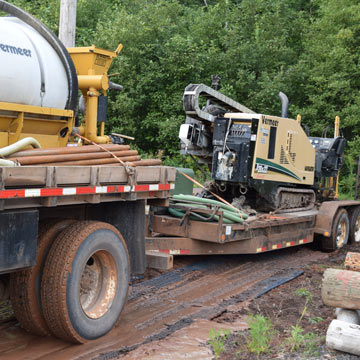 construction mats to drive on water truck and trailer with directional digger