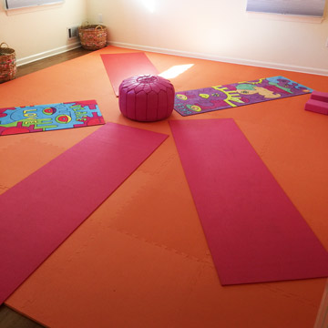 Orange playmats on wood floor in kids room