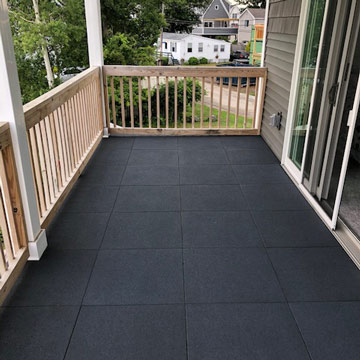 Interlocking rubber tiles over wooden deck