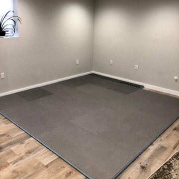 Boxing and workout space with padded floor mats