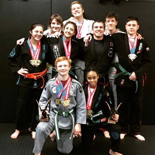 Justin Rader and teens with medals