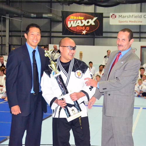 Reggie Madrigal with Master Jeff Kim and Master Rick Steinmaier