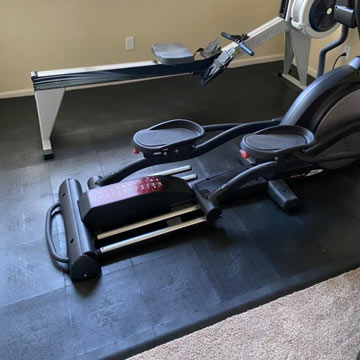 Rowing Machine and Elliptical Mat Over Carpet