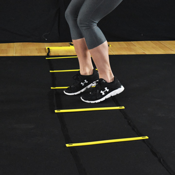 Foot quickness drills with agility ladder over plyometric rubber