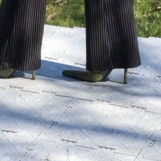 walking in high heels on the portable outdoor event tent tile